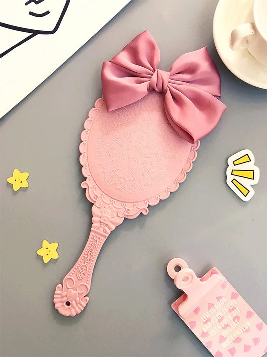 DA72 Cute bowknot creative handle makeup mirror hand-held beauty salon makeup princess mirror portable mirror Pink color